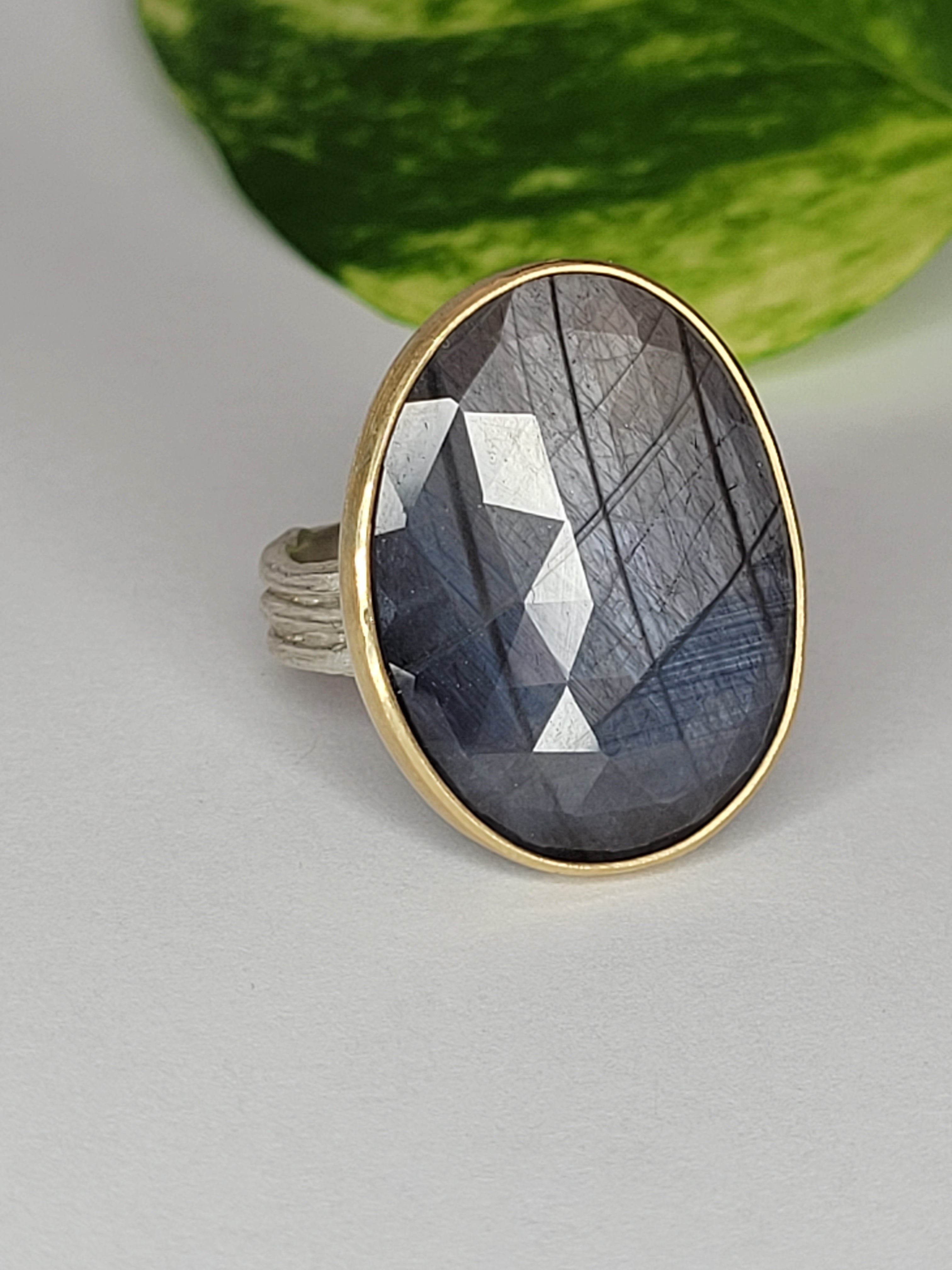 Blue/gray Sapphire (stone B) in Sterling Silver with a 18k Yellow Gold Bezel
