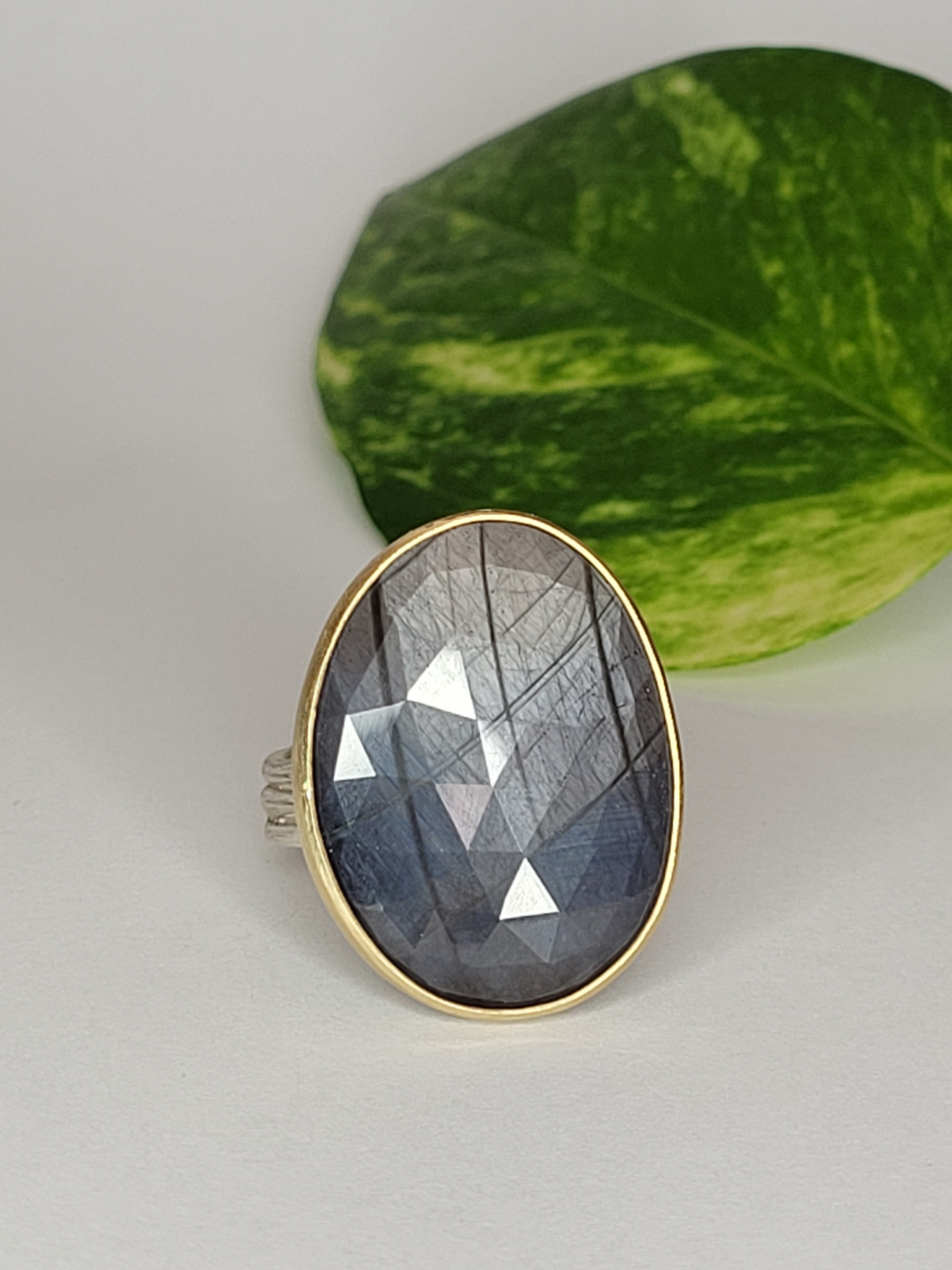 Blue/gray Sapphire (stone B) in Sterling Silver with a 18k Yellow Gold Bezel